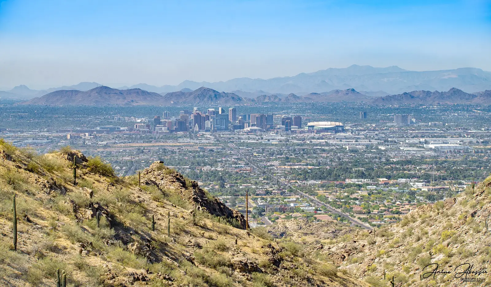 The Downtown Phoenix skyline against desert terrain and distant mountains, Arizona